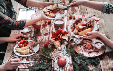 Flat-lay of friends hands eating and drinking together. Top view of people having party, gathering, celebrating together at wooden rustic table
