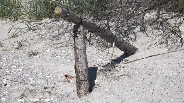 Broken barbed wire fence in the sand