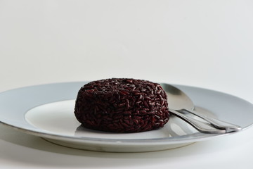 Cooked rice berry in plate on white background