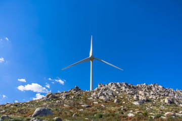 Fototapeta na wymiar View of a wind turbine on top of mountains
