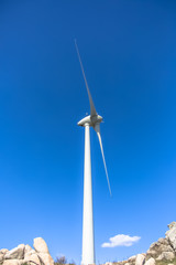 View of a wind turbine on top of mountains