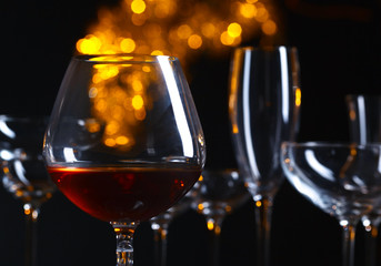Snifter of brandy on a dark background. Natural bokeh.