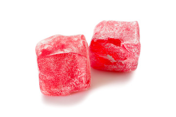 Turkish delight. Rose rahat locum, two pieces of sweet oriental delights in powered sugar. Close-up view.