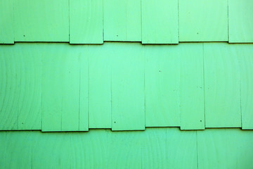 Abstract background image of green painted wooden building exterior surface