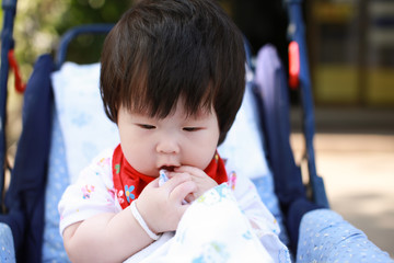 Cute asian Baby in a stroller