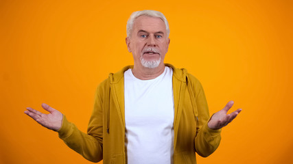 Retired person showing no idea gesture with hands, lack of information, answer