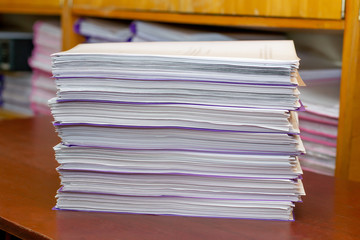 pile of documents on a wooden table. paperwork. data archive. office work