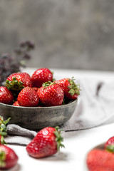 Soft focus of fresh ripe red strawberry in ceramic bowl