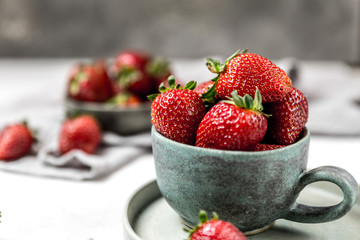 Soft focus of fresh ripe red strawberry in ceramic bowl