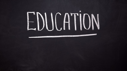 Education word written on blackboard, modern innovative technologies, schooling