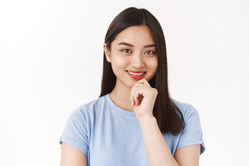 Smart creative freelance girl university student pondering new ideas smiling delighted touch chin thoughtful look camera amused intrigued wanna fulfill plan thinking standing white background