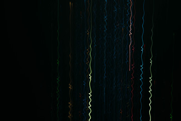 Fototapeta na wymiar Neon multicolor lights. Illuminated waveform vertical lines, falling sparkles. Dark abstract background.
