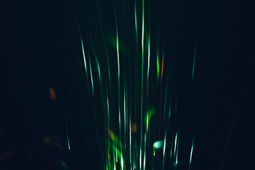 Night lamp glowing rays. Blur neon green lines burst. Dark abstract art background.