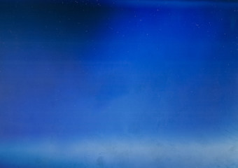 Blue light flare overlay. Aged filmstrip texture. Defocused glow.