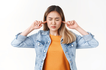 Cannot hear anymore. Fed up intense distressed young asian female student unable concentrate focus...