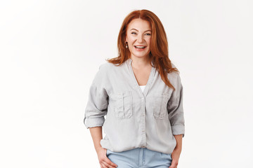 Fototapeta premium Elegant stylish pretty middle-aged female redhead wearing trendy blouse joyfully chatting smiling toothy entertained lively conversation girlfriends arrange small party nice relaxing atmosphere