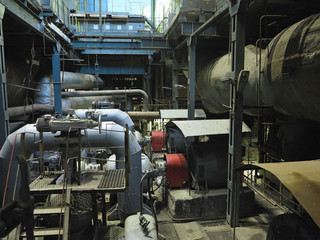 Fototapeta na wymiar Industrial big water pumps with electric motors, pipes, tubes, equipment and steam turbine at power plant