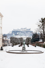 A mid winter view across Mirabell Gardens in Salzburg, Austria.  In the background can be seen Hohensalzburg Fortress sitting atop Festungsberg, a small hill.