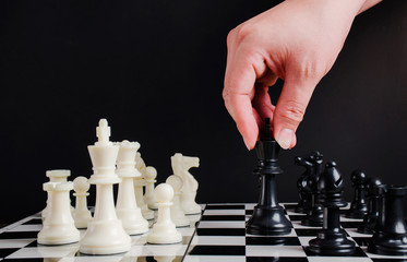 Hand of businessman moving chess board game in competition and development analysis for win and successful.