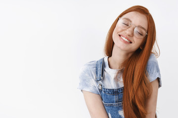 Romantic tender dreamy redhead girl tilt head close eyes and smile joyful, dreaming, fantasizing...