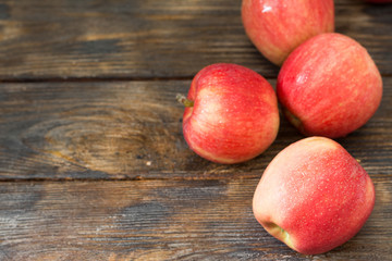 Red ripe apples on a wooden table