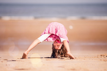 pretty young girl doing antics on the beach