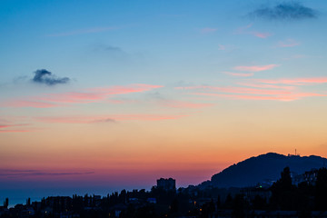Pink sunset with clouds over the city