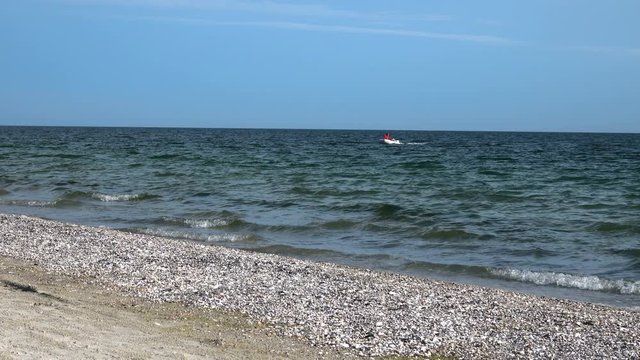 Man is swimming in an inflatable boat in the Black Sea