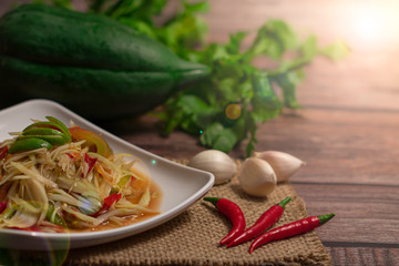 Papaya Spicy Salad on wodden background, Thai food,Thai papaya salad or we call 