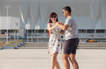 Young couple dances Caribbean Salsa. Social activity concept.