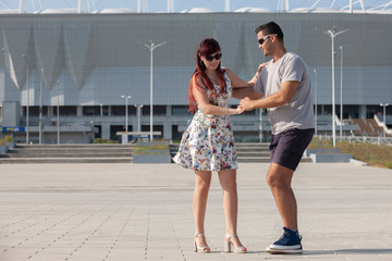 A young couple of dance instructors teaching salsa and bachata