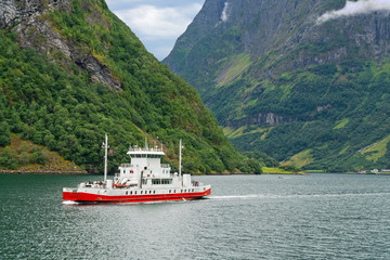 Ferry ship sailing in Sognefjord mountains, Norway