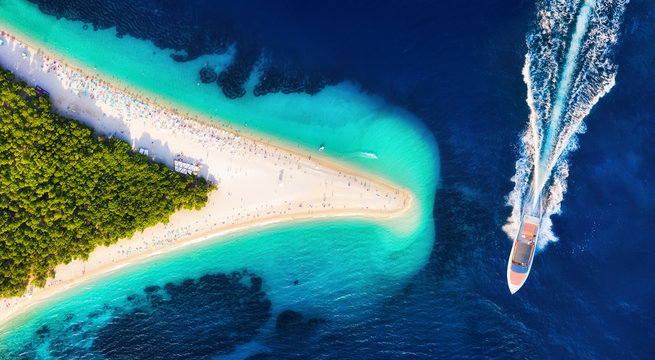 Croatia, Hvar island, Bol. Aerial view at the Zlatni Rat. Aerial view of luxury floating boat on blue Adriatic sea at sunny day. Travel - image