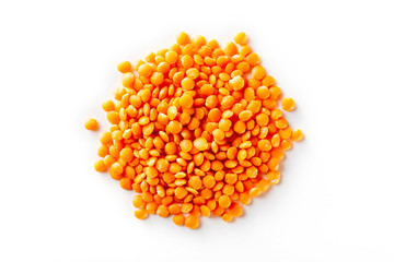 Macro top view image of red lentil pile isolated at white background.