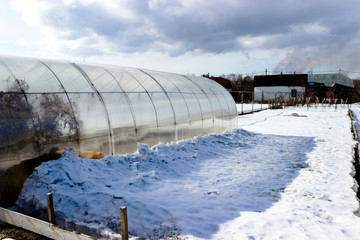 plastic hothouse in winter garden