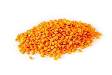 Macro image of red lentil pile isolated at white background.