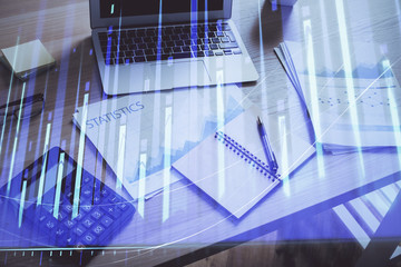 Financial chart drawing and table with computer on background. Multi exposure. Concept of...