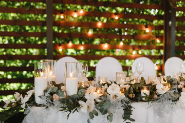 White flowers and candles on the wedding table