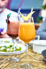 Cocktail or smoothie in a wine glass is on the table