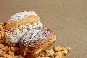 Cream-butter bread and ABC crackers on brown paper background.