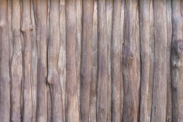 Wooden rustic fence of branches with nails background