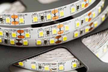 Macro image of LED white light tape twisted in a spiral.