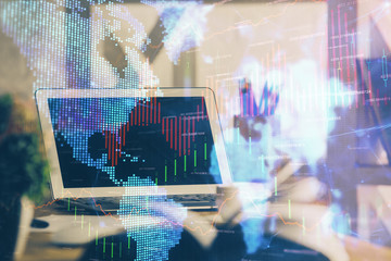 Financial graph colorful drawing and table with computer on background. Multi exposure. Concept of international markets.