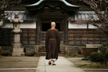 A monk in court yard of a monastery in Kamakura, Japan. - obrazy, fototapety, plakaty