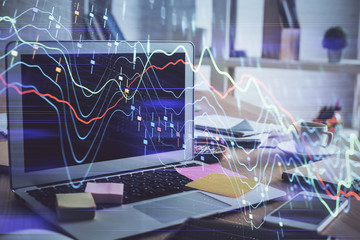 Financial market graph hologram and personal computer on background. Double exposure. Concept of forex.