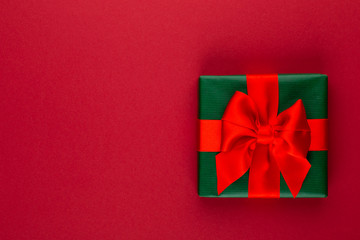 Christmas, holiday present box on red background.