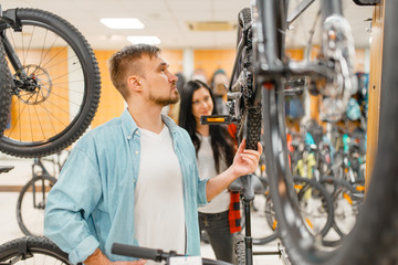Man checks bicycle disk breaks, shopping
