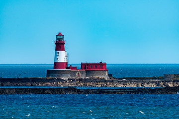 Fototapeta na wymiar Red & white lighthouse on the Farne Islands