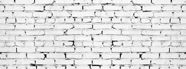Wide white brick wall texture. Old rough whitewashed brickwork. Grunge background