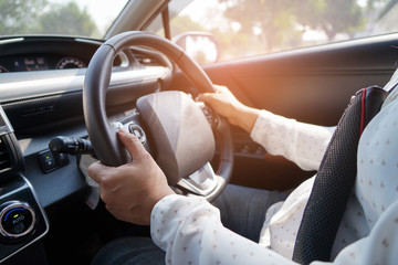 Woman driving car in enjoy holiday retirement life.